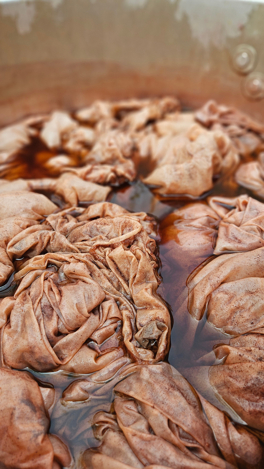 Fabrics soaking in natural dye bath